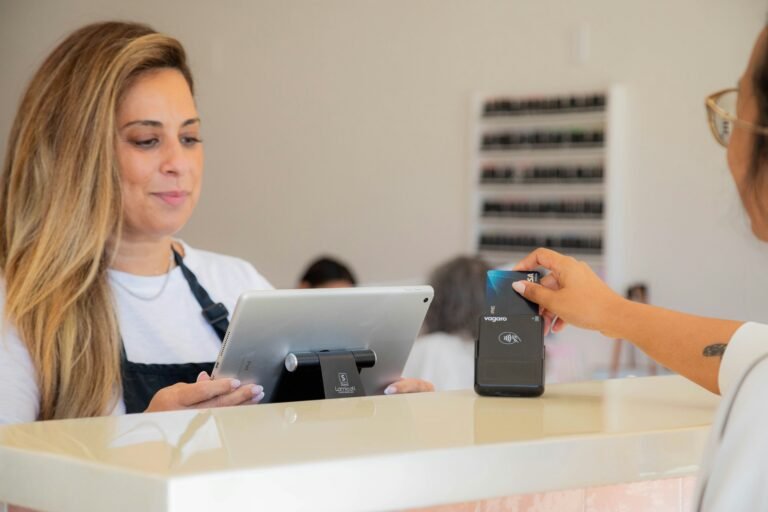 Image of a salon cashier using a modern POS system for billing